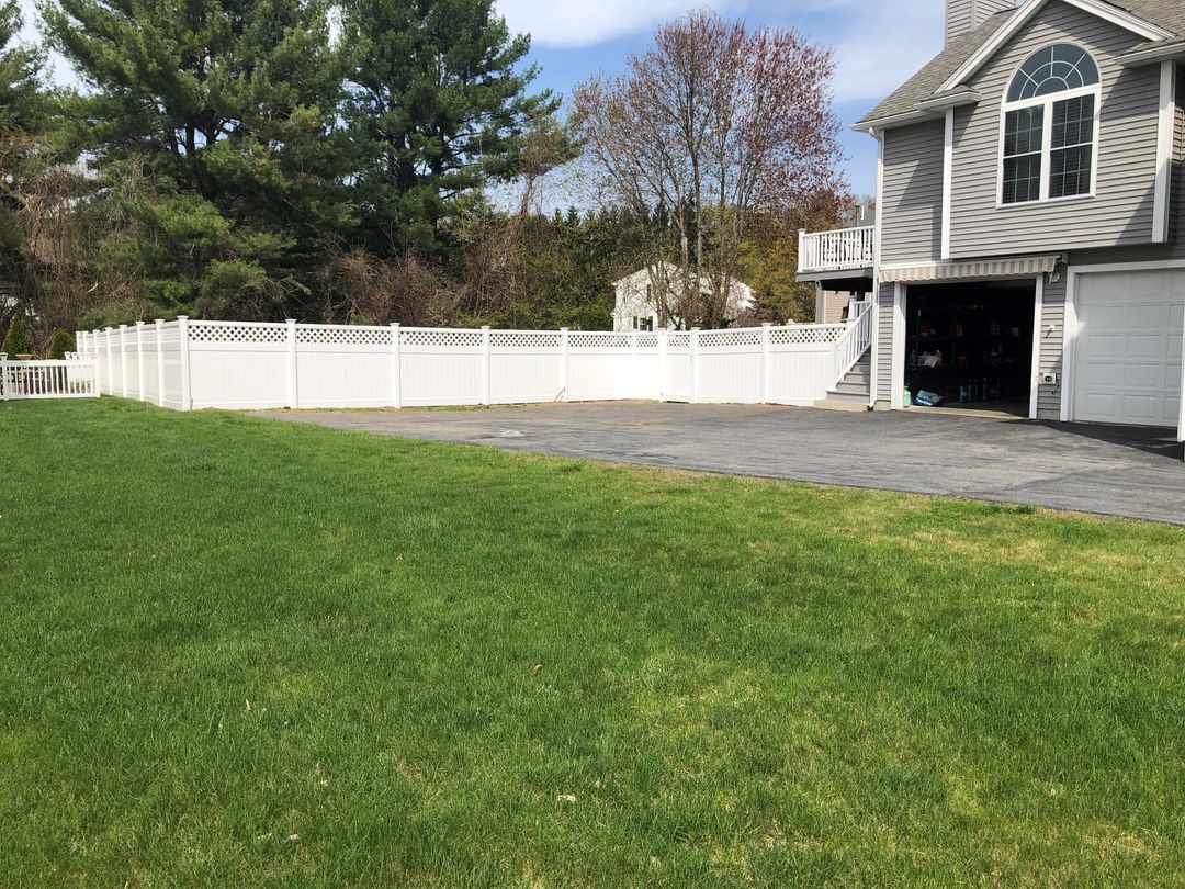 Photo of a white vinyl privacy fence at a residential home