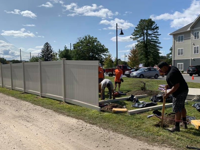 Photo of Massachusetts residential fencing company installing a vinyl fence